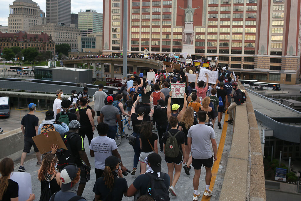 Demonstrators leave I-64 at the 14th Street exit after shutting it down Monday